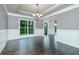 Dining room with hardwood floors, decorative wainscoting, modern lighting, and a large window with views of the backyard at 3118 Old Covington Hwy, Covington, GA 30014