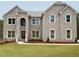 Stately brick home featuring a well-manicured lawn and a classic architectural design with multiple windows at 3118 Old Covington Hwy, Covington, GA 30014