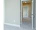 Neutral hallway with carpet and white trim, leading to several rooms, offering a spacious feel at 3118 Old Covington Hwy, Covington, GA 30014