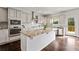 Gourmet kitchen featuring stainless steel appliances, spacious island, granite countertops, and custom cabinetry at 3118 Old Covington Hwy, Covington, GA 30014