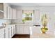 Kitchen with granite countertops, stainless steel appliances, and white cabinets, and hardwood flooring at 3118 Old Covington Hwy, Covington, GA 30014