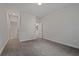 This is a bedroom with wall-to-wall carpeting and multiple doorways at 3128 Old Covington Hwy, Covington, GA 30014