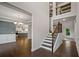Inviting foyer with staircase, hardwood floors, and open view to the kitchen and formal living areas at 3128 Old Covington Hwy, Covington, GA 30014