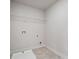 A laundry room with tile floor and a wire rack on the wall at 3128 Old Covington Hwy, Covington, GA 30014