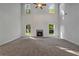 Spacious living room with a fireplace, high ceilings, and ample natural light from large windows at 3128 Old Covington Hwy, Covington, GA 30014