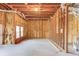 Unfinished basement with exposed insulation and framing, providing a blank canvas for customization and expansion at 5732 Ashleigh Walk Dr, Suwanee, GA 30024