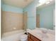 Bright bathroom with a tiled shower and tub, vanity, large mirror, and toilet at 5732 Ashleigh Walk Dr, Suwanee, GA 30024