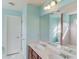 Bathroom with dual sinks, a large mirror, and blue walls, providing a bright and functional space at 5732 Ashleigh Walk Dr, Suwanee, GA 30024