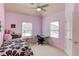 Cozy bedroom with pink walls, a single bed, desk, and ample natural light from the windows, creating a comfortable space at 5732 Ashleigh Walk Dr, Suwanee, GA 30024