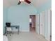 Bright bedroom with desk, chair, and a ceiling fan; well-lit with neutral carpet at 5732 Ashleigh Walk Dr, Suwanee, GA 30024