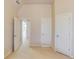 Neutral bedroom showing door access and a peek into the home's railing system and chandelier at 5732 Ashleigh Walk Dr, Suwanee, GA 30024