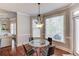 Dining area with modern chairs, a glass table, a pendant chandelier, and lots of natural light at 5732 Ashleigh Walk Dr, Suwanee, GA 30024
