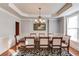 Charming dining room with hardwood floors, wainscoting, and stylish chandelier at 5732 Ashleigh Walk Dr, Suwanee, GA 30024