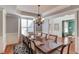 Elegant dining room featuring a large table, decorative chandelier, and classic molding at 5732 Ashleigh Walk Dr, Suwanee, GA 30024