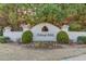 Community entrance sign at Ashleigh Walk with well-kept landscaping and manicured hedges at 5732 Ashleigh Walk Dr, Suwanee, GA 30024