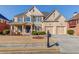 Beautiful two-story brick home with a manicured front yard and a two-car garage in a suburban neighborhood at 5732 Ashleigh Walk Dr, Suwanee, GA 30024