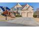 Charming two-story brick home with landscaped front yard and inviting curb appeal at 5732 Ashleigh Walk Dr, Suwanee, GA 30024