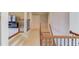 Hallway with carpeted stairs, decorative railings, and entryways to other rooms at 5732 Ashleigh Walk Dr, Suwanee, GA 30024