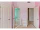 Hallway with multiple doorways and a small bookshelf, providing access to different areas of the house at 5732 Ashleigh Walk Dr, Suwanee, GA 30024