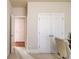 Hallway with white doors, chair, and trim work at 5732 Ashleigh Walk Dr, Suwanee, GA 30024