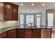 Kitchen featuring dark granite countertops, stainless steel appliances, and rich wood cabinets at 5732 Ashleigh Walk Dr, Suwanee, GA 30024