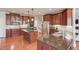 Gourmet kitchen with stainless steel appliances, granite countertops, a central island, and beautiful wood cabinets at 5732 Ashleigh Walk Dr, Suwanee, GA 30024