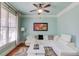 Cozy living room with blue walls, white sectional sofa and natural light at 5732 Ashleigh Walk Dr, Suwanee, GA 30024