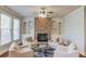 Inviting living room with stone fireplace, built-in shelving, and comfortable seating arrangement at 5732 Ashleigh Walk Dr, Suwanee, GA 30024