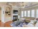Cozy living room with coffered ceilings, a fireplace, built-in shelves, and large windows offering plenty of light at 5732 Ashleigh Walk Dr, Suwanee, GA 30024