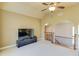 Bright living room with neutral walls, a ceiling fan, and archways leading to other rooms in the home at 5732 Ashleigh Walk Dr, Suwanee, GA 30024