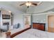 Bright main bedroom featuring a fireplace, sitting area, and dresser at 5732 Ashleigh Walk Dr, Suwanee, GA 30024