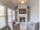 Stylish sitting room featuring a fireplace, natural light, and built-in shelving at 5732 Ashleigh Walk Dr, Suwanee, GA 30024