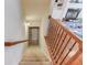 View of the staircase leading downstairs, complemented by wood and iron railings and modern lighting at 5732 Ashleigh Walk Dr, Suwanee, GA 30024