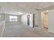 Large finished basement with neutral walls and carpet and an adjacent bathroom at 600 Canterbury Ln, Lawrenceville, GA 30046