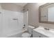 Well-lit bathroom featuring a shower-tub combo, vanity, and a neutral color palette at 600 Canterbury Ln, Lawrenceville, GA 30046
