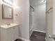 Clean bathroom with wood-look flooring and vanity with mirror at 600 Canterbury Ln, Lawrenceville, GA 30046