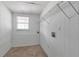 Utility room with hookups, shelving, and a small window for natural light at 600 Canterbury Ln, Lawrenceville, GA 30046