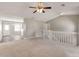 Spacious living area with plush carpeting, open layout, and a ceiling fan for added comfort at 600 Canterbury Ln, Lawrenceville, GA 30046