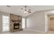 Cozy living room featuring a stone fireplace, plush carpeting, and bright windows at 600 Canterbury Ln, Lawrenceville, GA 30046