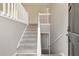 Interior view of a well-lit staircase with modern white railings leading to the upper level at 600 Canterbury Ln, Lawrenceville, GA 30046