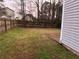 Wide backyard with a privacy fence, a lawn, and a partial patio at 115 Glynn Addy Dr, Stockbridge, GA 30281