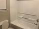 Clean white bathtub and toilet in a bright bathroom with wood look flooring at 115 Glynn Addy Dr, Stockbridge, GA 30281