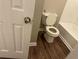 Bathroom with white toilet, bathtub, and wood look flooring at 115 Glynn Addy Dr, Stockbridge, GA 30281