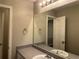 Well-lit bathroom with a large mirror and vanity with sink and a door at 115 Glynn Addy Dr, Stockbridge, GA 30281