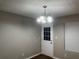 Cozy dining area featuring modern chandelier and a door with a window at 115 Glynn Addy Dr, Stockbridge, GA 30281