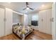 Bright bedroom featuring hardwood floors and custom built-in cabinets for ample storage at 2418 Claude Brewer Rd, Loganville, GA 30052