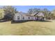 Charming single-story home with white siding, black trim and lovely front porch on a large lawn at 2418 Claude Brewer Rd, Loganville, GA 30052