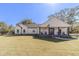 Attractive single-story home boasting a classic design, charming front porch and lush green lawn at 2418 Claude Brewer Rd, Loganville, GA 30052