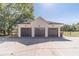 A spacious detached three-car garage with dark doors and concrete driveway at 2418 Claude Brewer Rd, Loganville, GA 30052