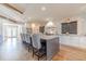 Stylish kitchen featuring a large island with bar seating, stainless appliances, and herringbone backsplash at 2418 Claude Brewer Rd, Loganville, GA 30052
